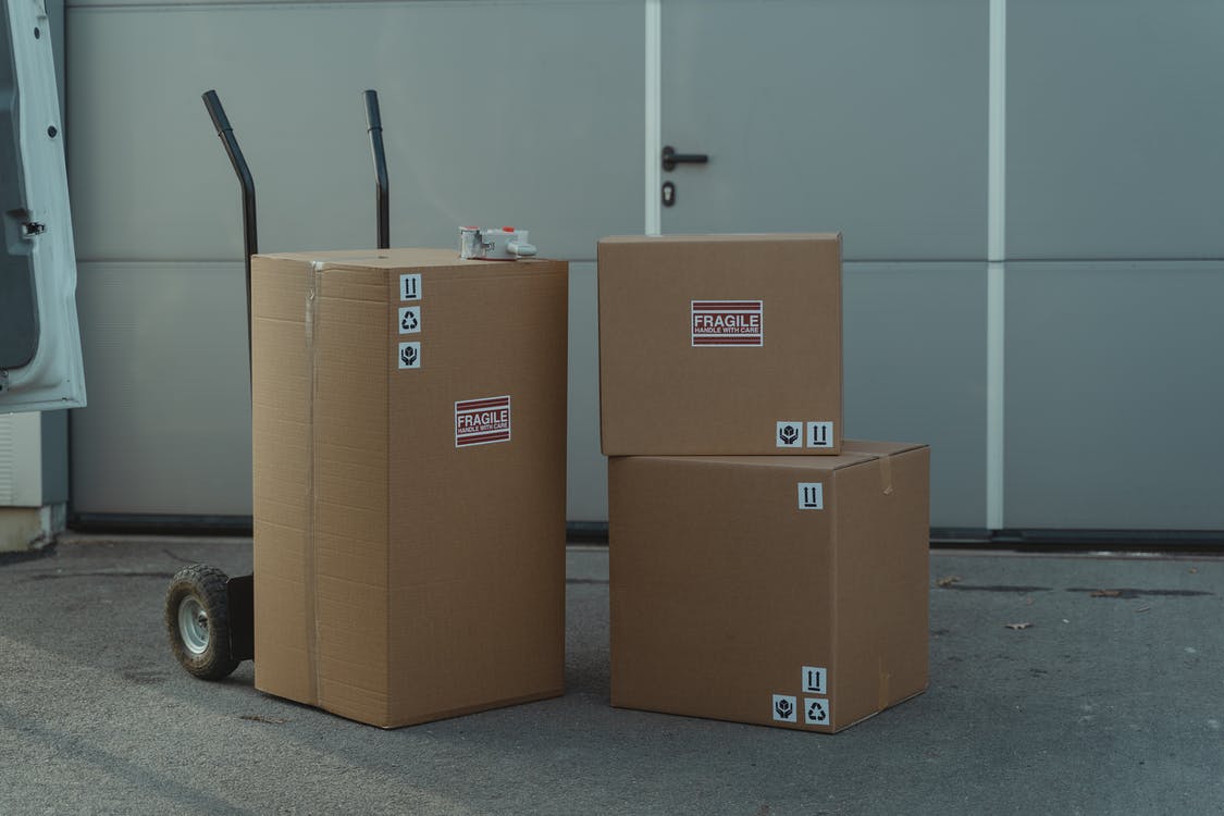 Three Boxes with a dolly stacked outside