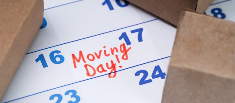 A close-up of a calendar with a date marked “Moving Day”.